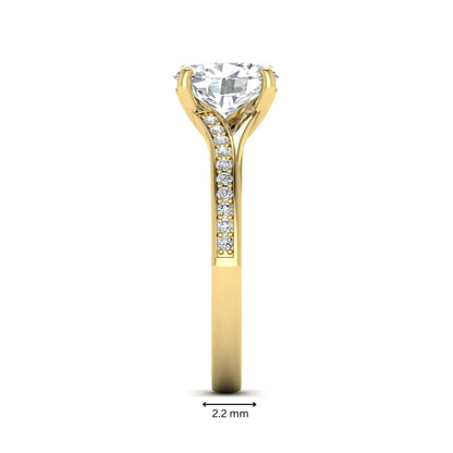 Oval cut lab grown diamond split shank pavé engagement ring with four-prong setting and yellow gold tone band.