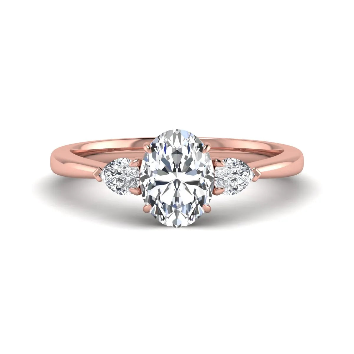 Oval cut lab grown diamond three stone engagement ring with pear cut side diamonds and prong setting in rose gold tone.
