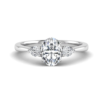 Oval cut lab grown diamond three stone engagement ring with pear cut side diamonds and prong setting in white gold tone.