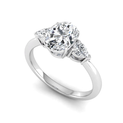 Oval cut lab grown diamond three stone engagement ring with pear cut side diamonds and prong setting in white gold tone.
