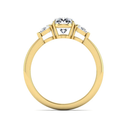 Oval cut lab grown diamond three stone engagement ring with pear cut side diamonds and prong setting in yellow gold tone.