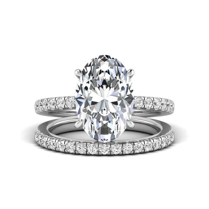 Oval Cut Pavé Solitaire Lab Grown Diamond Engagement Ring Set featuring a 3.92 carat IGI Certified oval diamond with a matching pavé diamond wedding band in white gold.