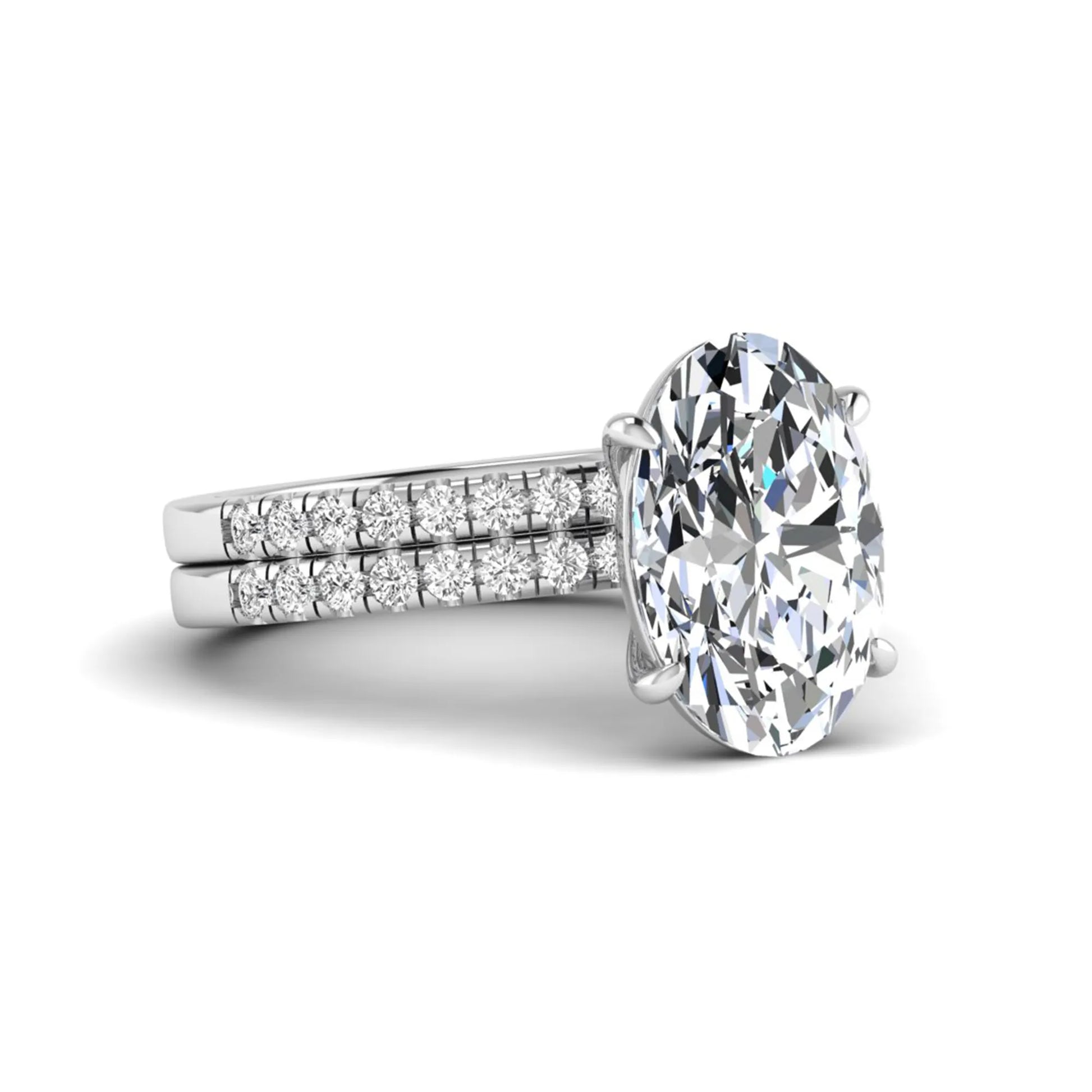 Oval Cut Pavé Solitaire Lab Grown Diamond Engagement Ring Set featuring a 3.92 carat IGI Certified oval diamond with a matching pavé diamond wedding band in white gold.