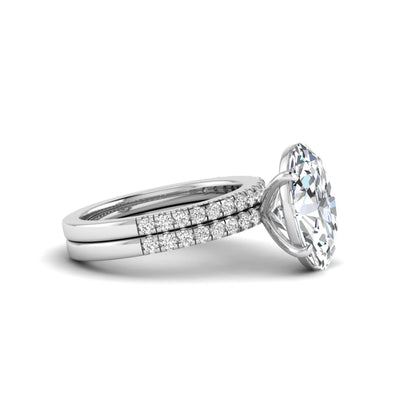 Oval Cut Pavé Solitaire Lab Grown Diamond Engagement Ring Set featuring a 3.92 carat IGI Certified oval diamond with a matching pavé diamond wedding band in white gold.