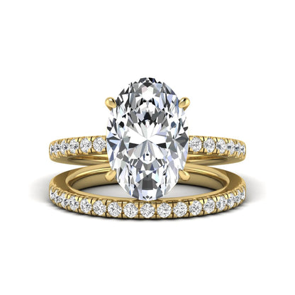 Oval Cut Pavé Solitaire Lab Grown Diamond Engagement Ring Set featuring a 3.92 carat IGI Certified oval diamond with a matching pavé diamond wedding band in yellow gold.