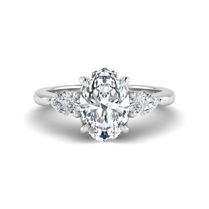 Oval cut three stone lab grown diamond engagement ring in white gold featuring a 1.31 carat IGI certified center diamond with pear cut side diamonds.
