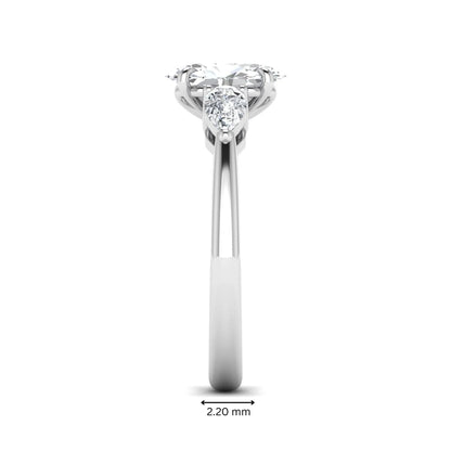 Oval cut three stone lab grown diamond engagement ring in white gold featuring a 1.31 carat IGI certified center diamond with pear cut side diamonds.
