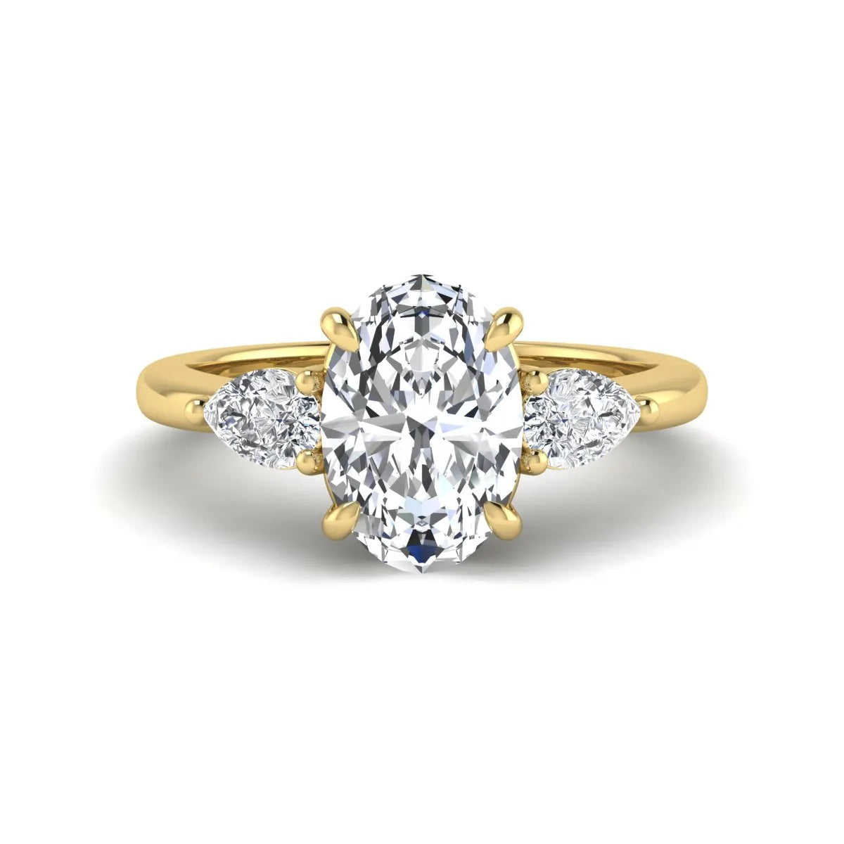 Oval cut three stone lab grown diamond engagement ring in yellow gold featuring a 1.31 carat IGI certified center diamond with pear cut side diamonds.