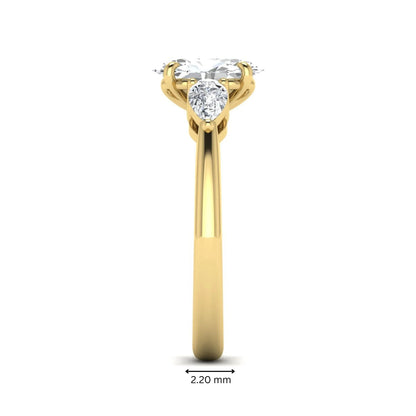 Oval cut three stone lab grown diamond engagement ring in yellow gold featuring a 1.31 carat IGI certified center diamond with pear cut side diamonds.