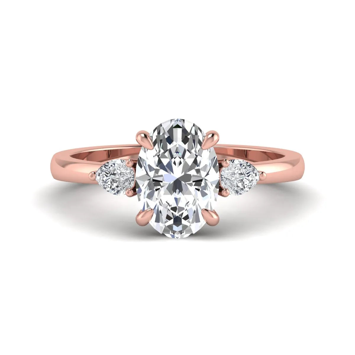 Oval cut lab grown diamond three stone engagement ring with pear side diamonds in rose gold.