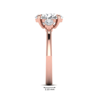 Oval cut lab grown diamond three stone engagement ring with pear side diamonds in rose gold.