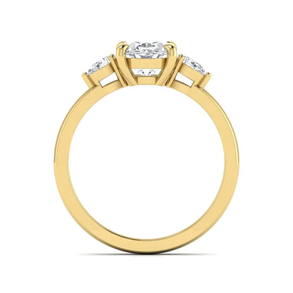Oval cut lab grown diamond three stone engagement ring with pear side diamonds in yellow gold.