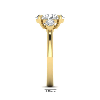 Oval cut lab grown diamond three stone engagement ring with pear side diamonds in yellow gold.