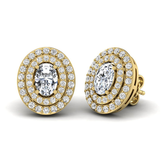 Oval cut lab grown diamond stud earrings featuring a double halo of round cut diamonds, prong setting, push back closure, and yellow gold tone design.