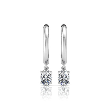 Oval cut lab grown diamond drop huggie hoop earrings featuring a four prong drop setting, hinged snap closure, and polished white gold tone finish.