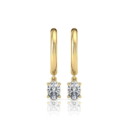 Oval cut lab grown diamond drop huggie hoop earrings featuring a four prong drop setting, hinged snap closure, and polished yellow gold tone finish.