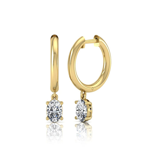 Oval cut lab grown diamond drop huggie hoop earrings featuring a four prong drop setting, hinged snap closure, and polished yellow gold tone finish.