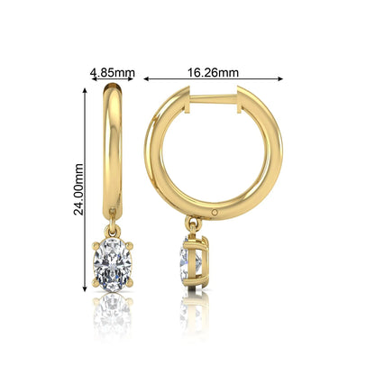Oval cut lab grown diamond drop huggie hoop earrings featuring a four prong drop setting, hinged snap closure, and polished yellow gold tone finish.