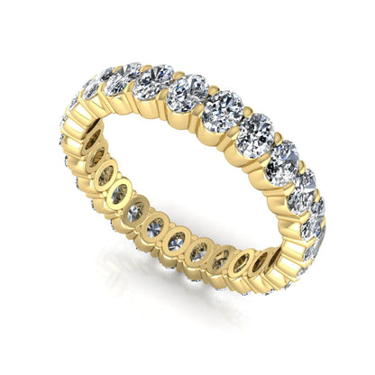 Oval cut lab grown diamond eternity band featuring a continuous row of brilliant shared-prong set diamonds in a timeless luxury design in yellow gold