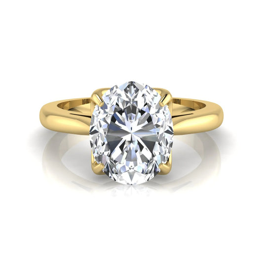 Oval cut lab grown diamond solitaire engagement ring featuring a classic four-prong setting with a yellow gold tone band.