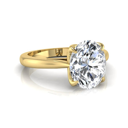 Oval cut lab grown diamond solitaire engagement ring featuring a classic four-prong setting with a yellow gold tone band.