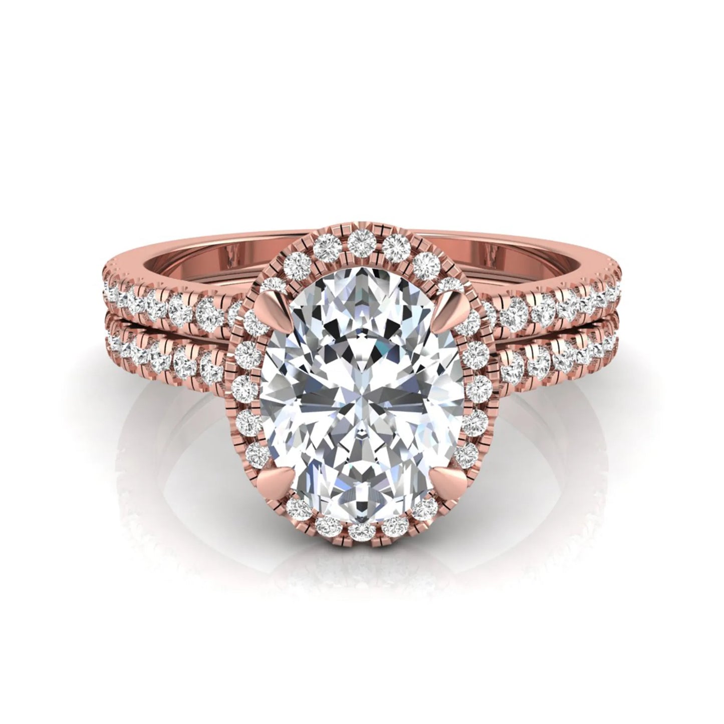 Oval cut lab grown diamond bridal ring set featuring an IGI certified center diamond with a round diamond halo and matching pavé wedding band in rose gold