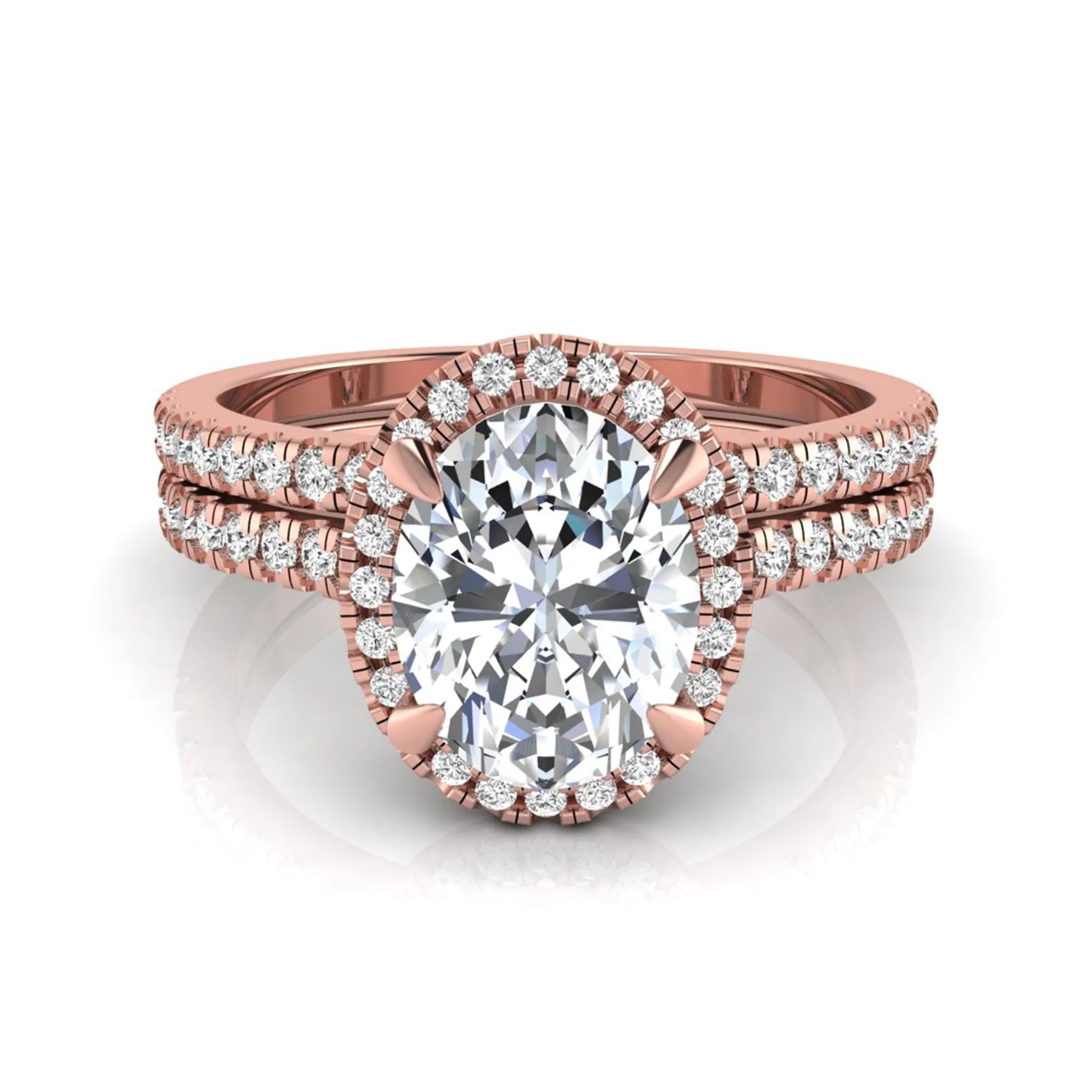 Oval cut lab grown diamond bridal ring set featuring an IGI certified center diamond with a round diamond halo and matching pavé wedding band in rose gold