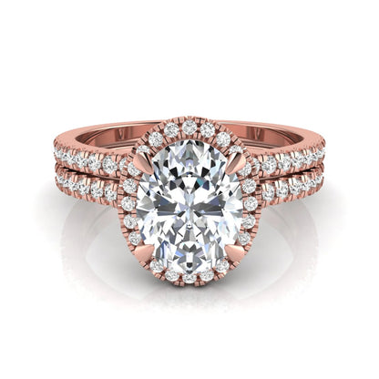 Oval cut lab grown diamond bridal ring set featuring an IGI certified center diamond with a round diamond halo and matching pavé wedding band in rose gold