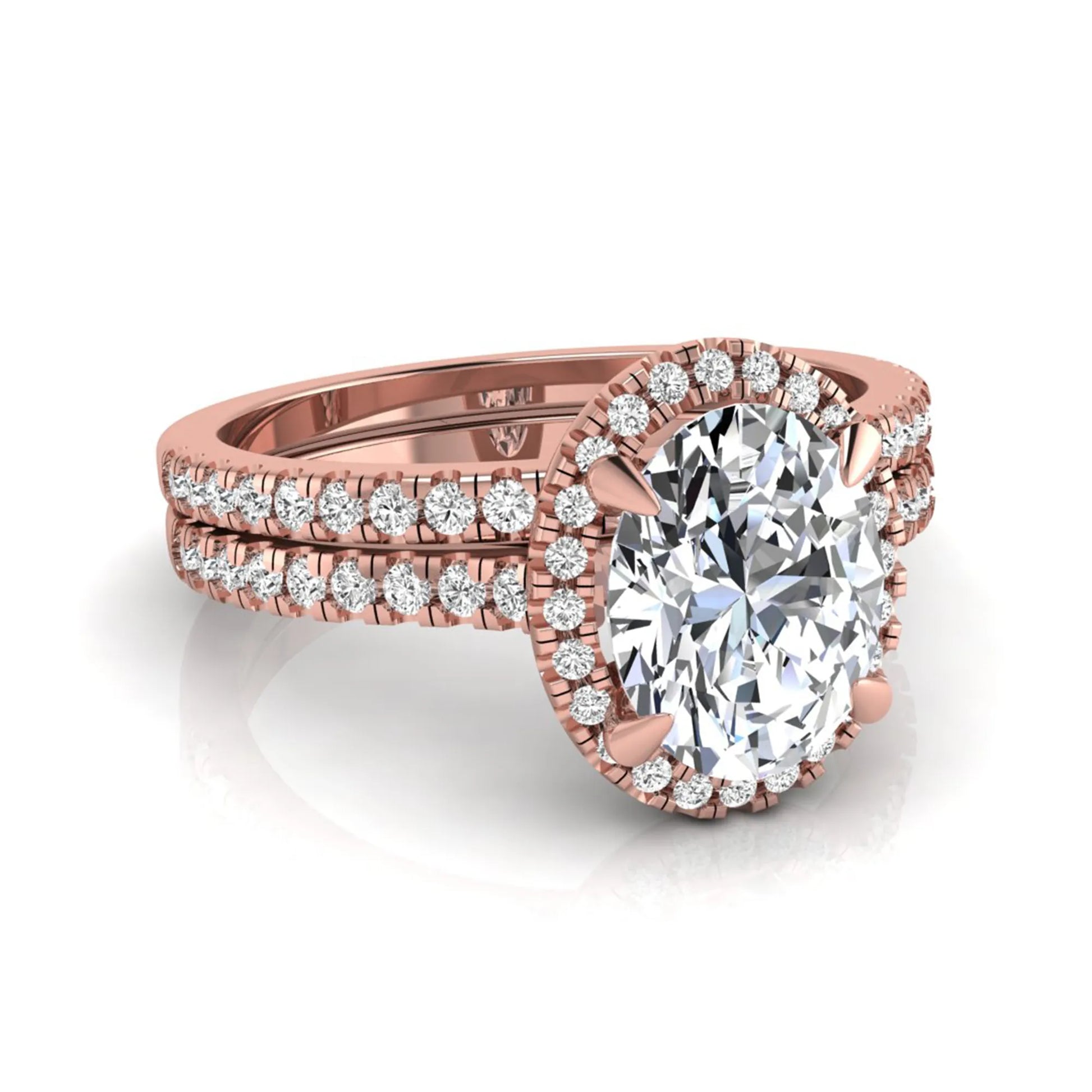 Oval cut lab grown diamond bridal ring set featuring an IGI certified center diamond with a round diamond halo and matching pavé wedding band in rose gold
