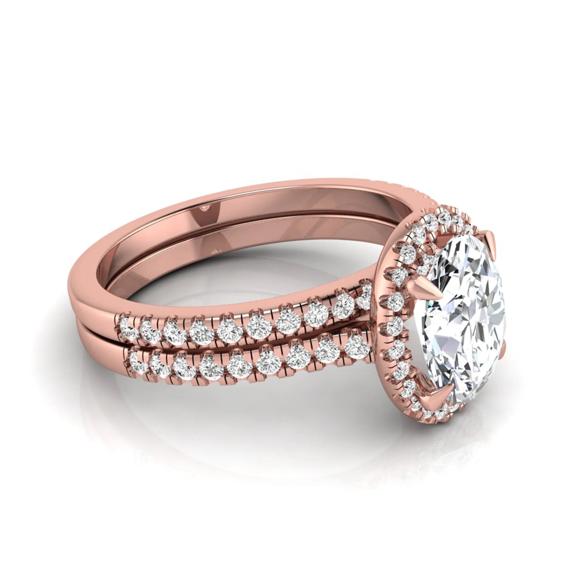 Oval cut lab grown diamond bridal ring set featuring an IGI certified center diamond with a round diamond halo and matching pavé wedding band in rose gold