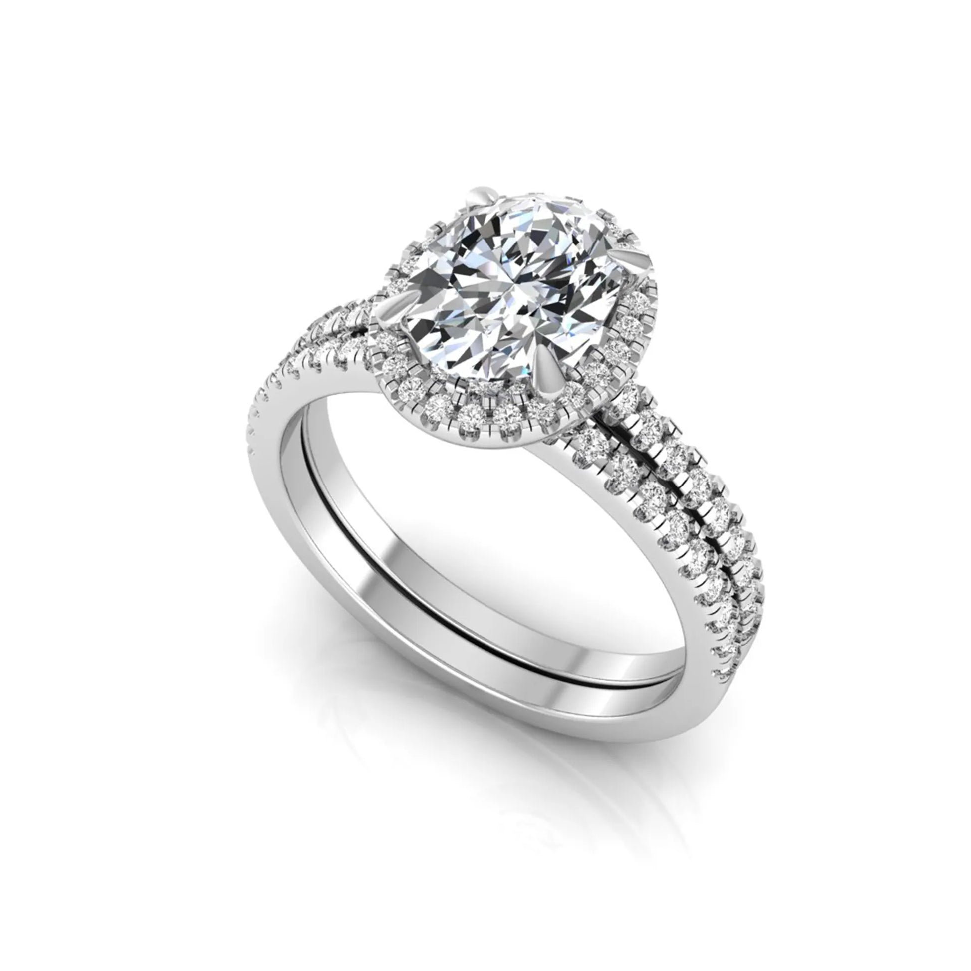 Oval cut lab grown diamond bridal ring set featuring an IGI certified center diamond with a round diamond halo and matching pavé wedding band in white gold