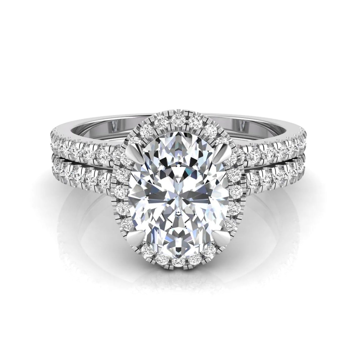 Oval cut lab grown diamond bridal ring set featuring an IGI certified center diamond with a round diamond halo and matching pavé wedding band in white gold