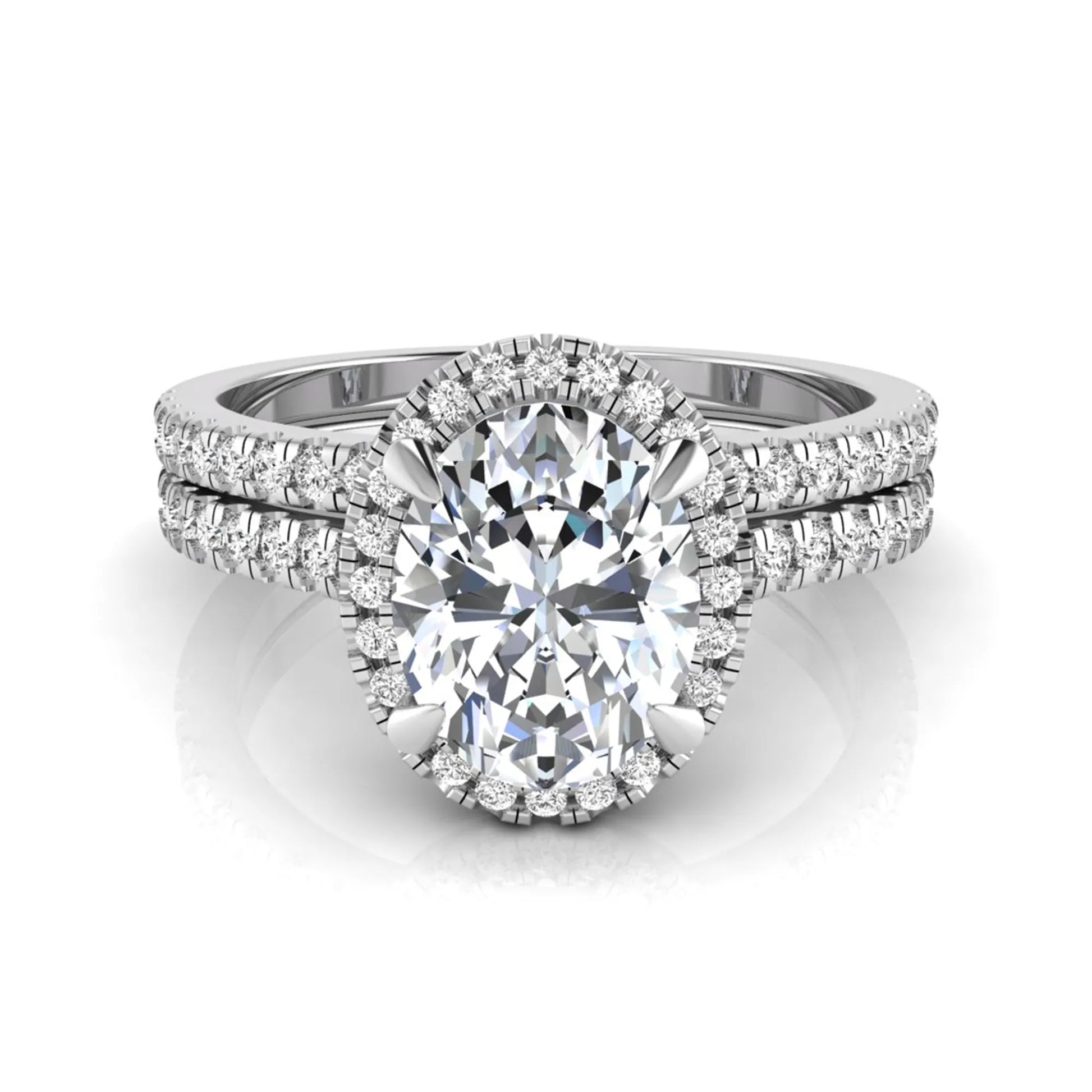 Oval cut lab grown diamond bridal ring set featuring an IGI certified center diamond with a round diamond halo and matching pavé wedding band in white gold