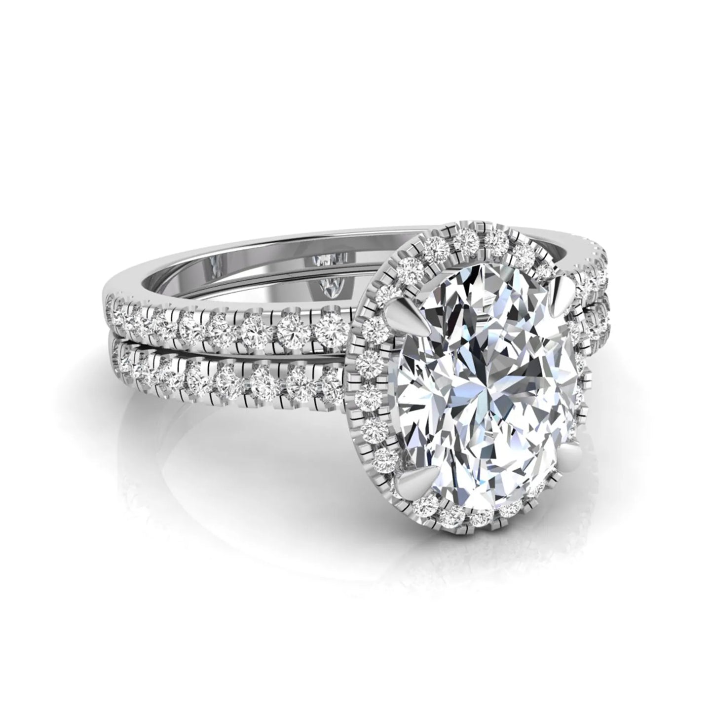 Oval cut lab grown diamond bridal ring set featuring an IGI certified center diamond with a round diamond halo and matching pavé wedding band in white gold