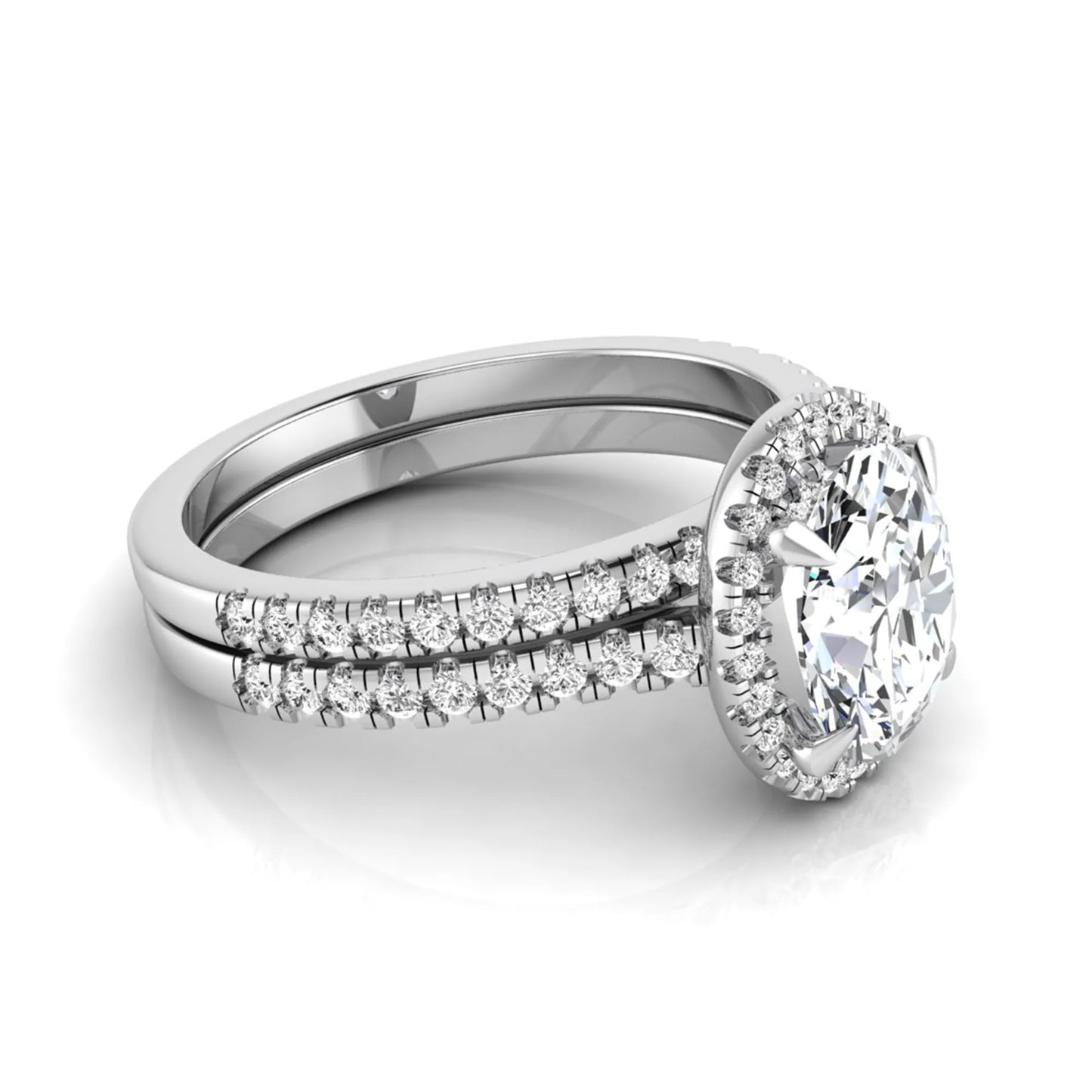 Oval cut lab grown diamond bridal ring set featuring an IGI certified center diamond with a round diamond halo and matching pavé wedding band in white gold