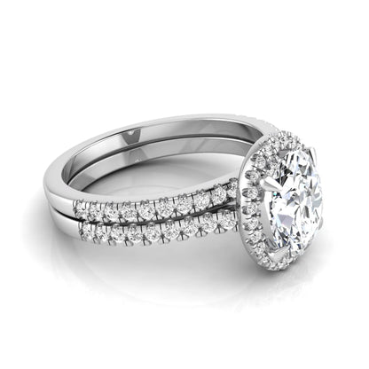 Oval cut lab grown diamond bridal ring set featuring an IGI certified center diamond with a round diamond halo and matching pavé wedding band in white gold