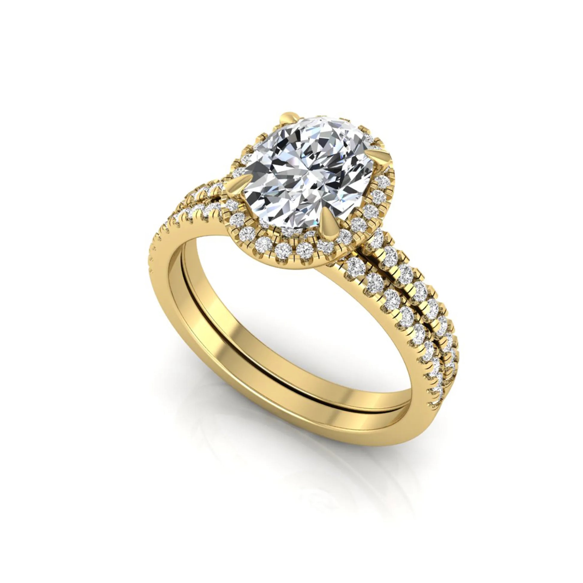 Oval cut lab grown diamond bridal ring set featuring an IGI certified center diamond with a round diamond halo and matching pavé wedding band in yellow gold