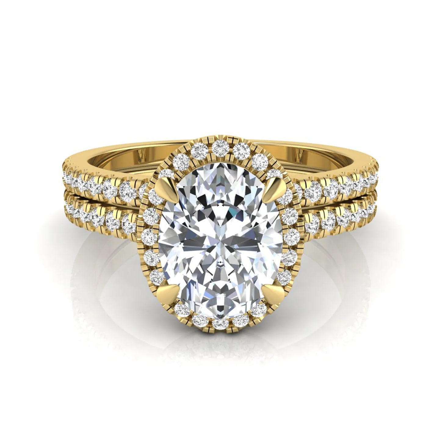 Oval cut lab grown diamond bridal ring set featuring an IGI certified center diamond with a round diamond halo and matching pavé wedding band in yellow gold