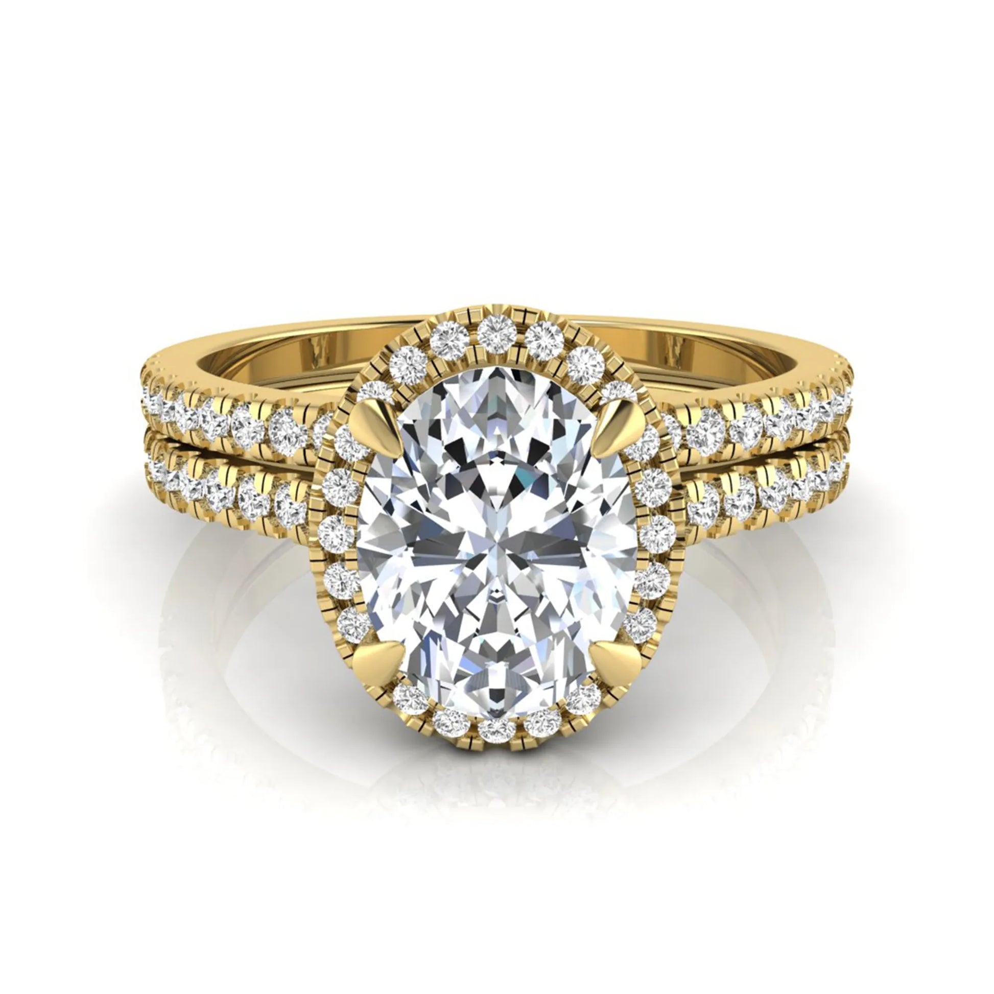 Oval cut lab grown diamond bridal ring set featuring an IGI certified center diamond with a round diamond halo and matching pavé wedding band in yellow gold