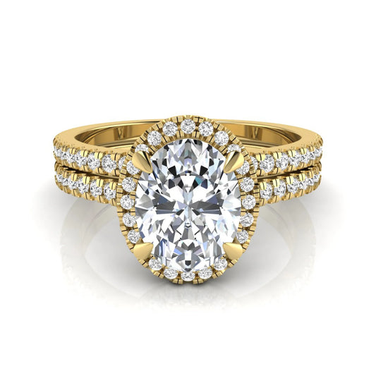 Oval cut lab grown diamond bridal ring set featuring an IGI certified center diamond with a round diamond halo and matching pavé wedding band in yellow gold