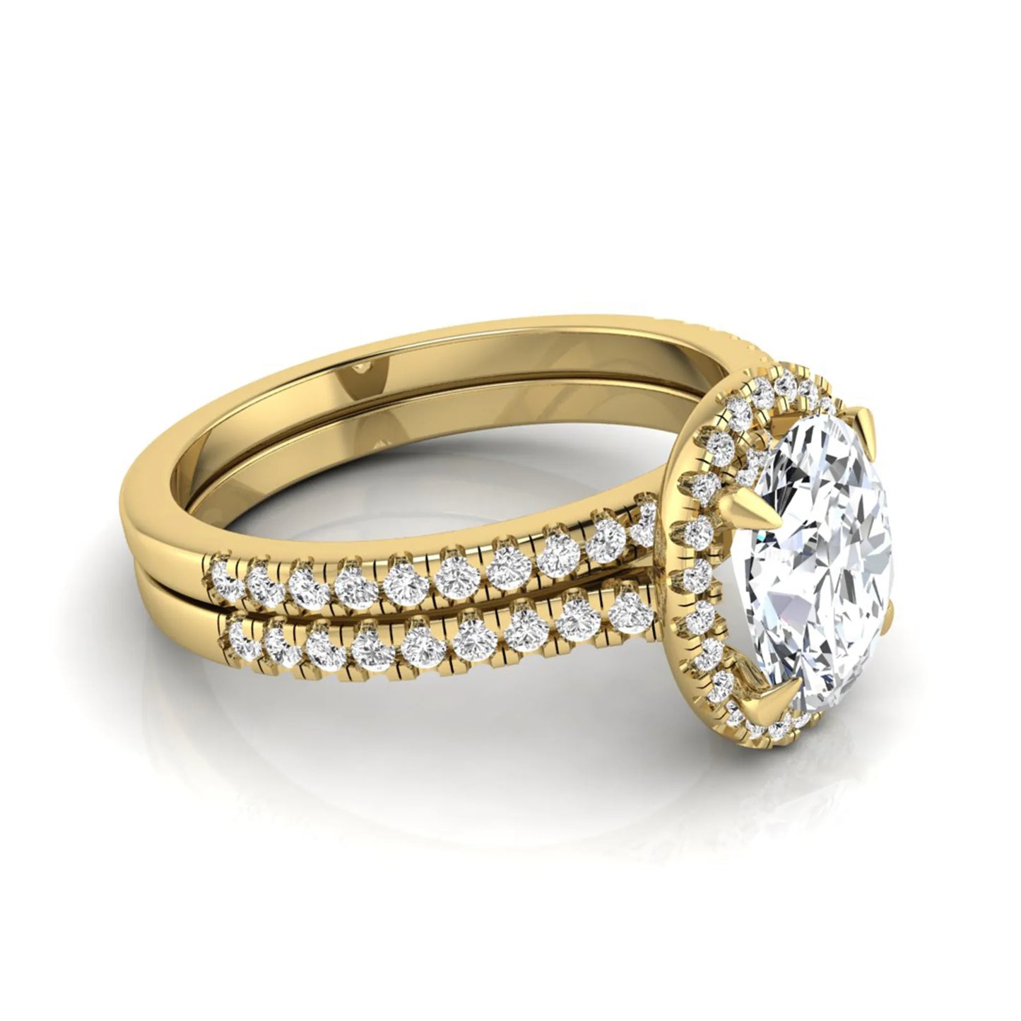 Oval cut lab grown diamond bridal ring set featuring an IGI certified center diamond with a round diamond halo and matching pavé wedding band in yellow gold
