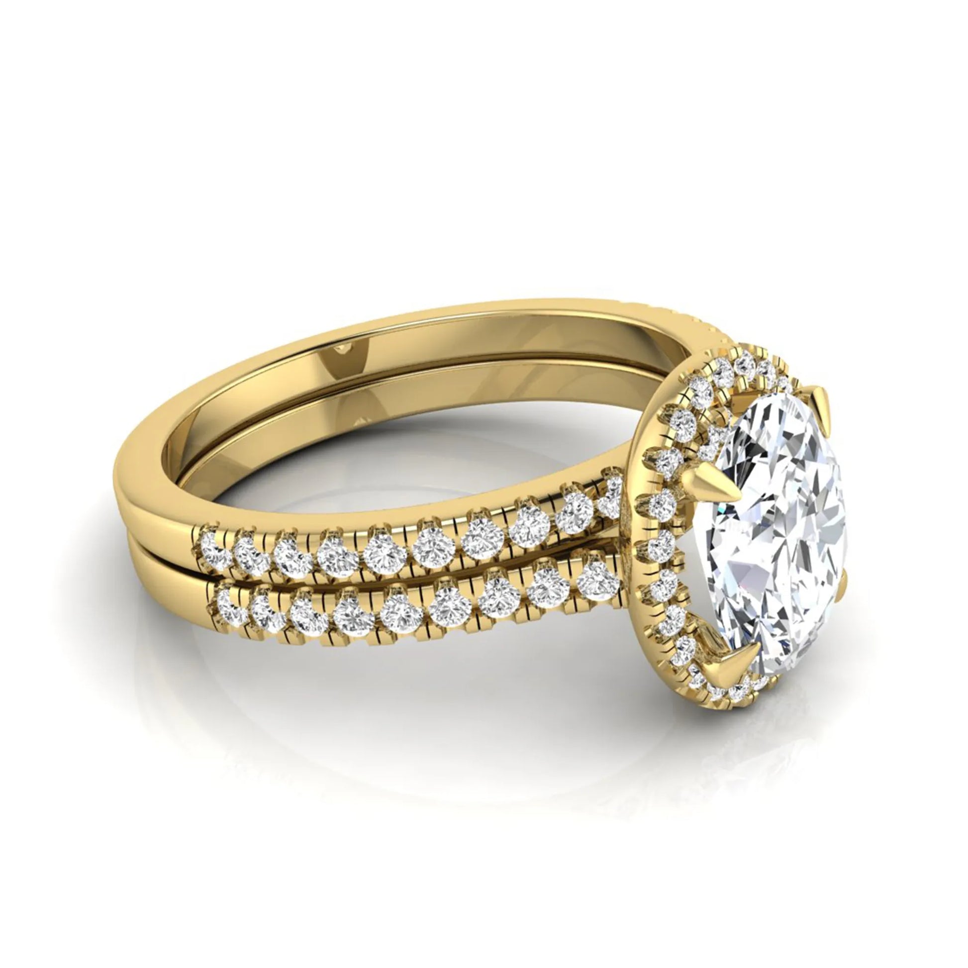 Oval cut lab grown diamond bridal ring set featuring an IGI certified center diamond with a round diamond halo and matching pavé wedding band in yellow gold