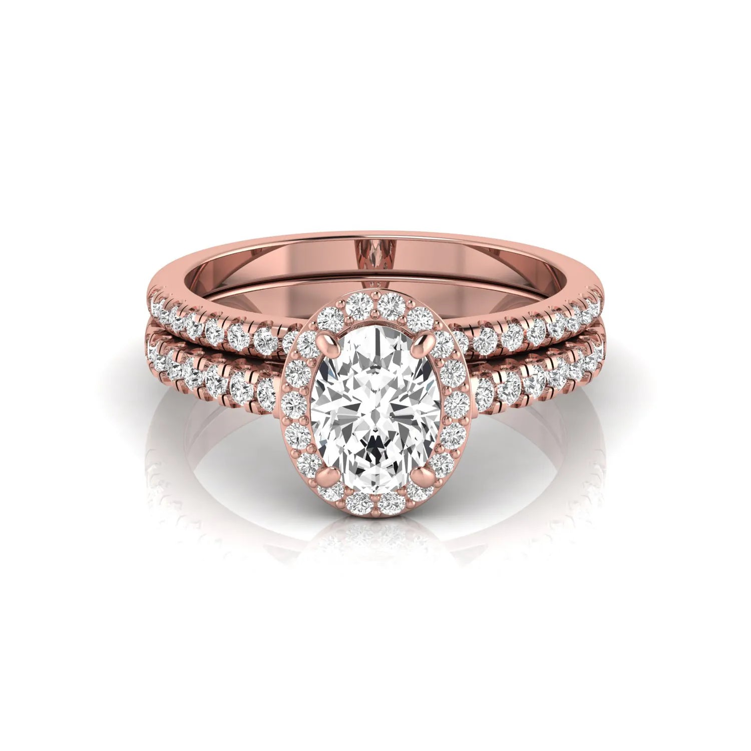 Oval halo lab grown diamond bridal ring set featuring an IGI certified oval cut center diamond with round pavé diamonds in a classic halo setting and matching wedding band in rose gold
