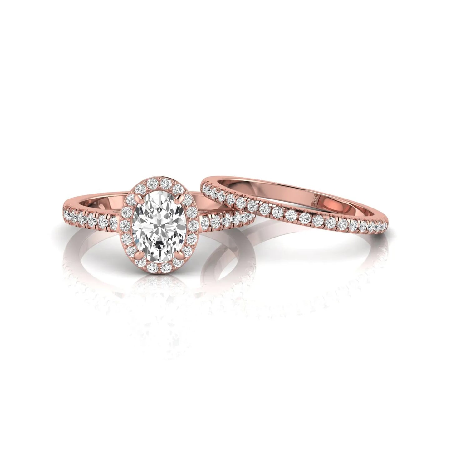 Oval halo lab grown diamond bridal ring set featuring an IGI certified oval cut center diamond with round pavé diamonds in a classic halo setting and matching wedding band in rose gold