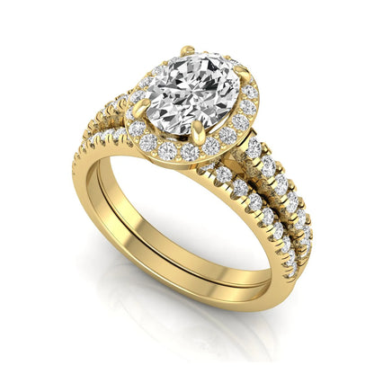 Oval halo lab grown diamond bridal ring set featuring an IGI certified oval cut center diamond with round pavé diamonds in a classic halo setting and matching wedding band in yellow gold