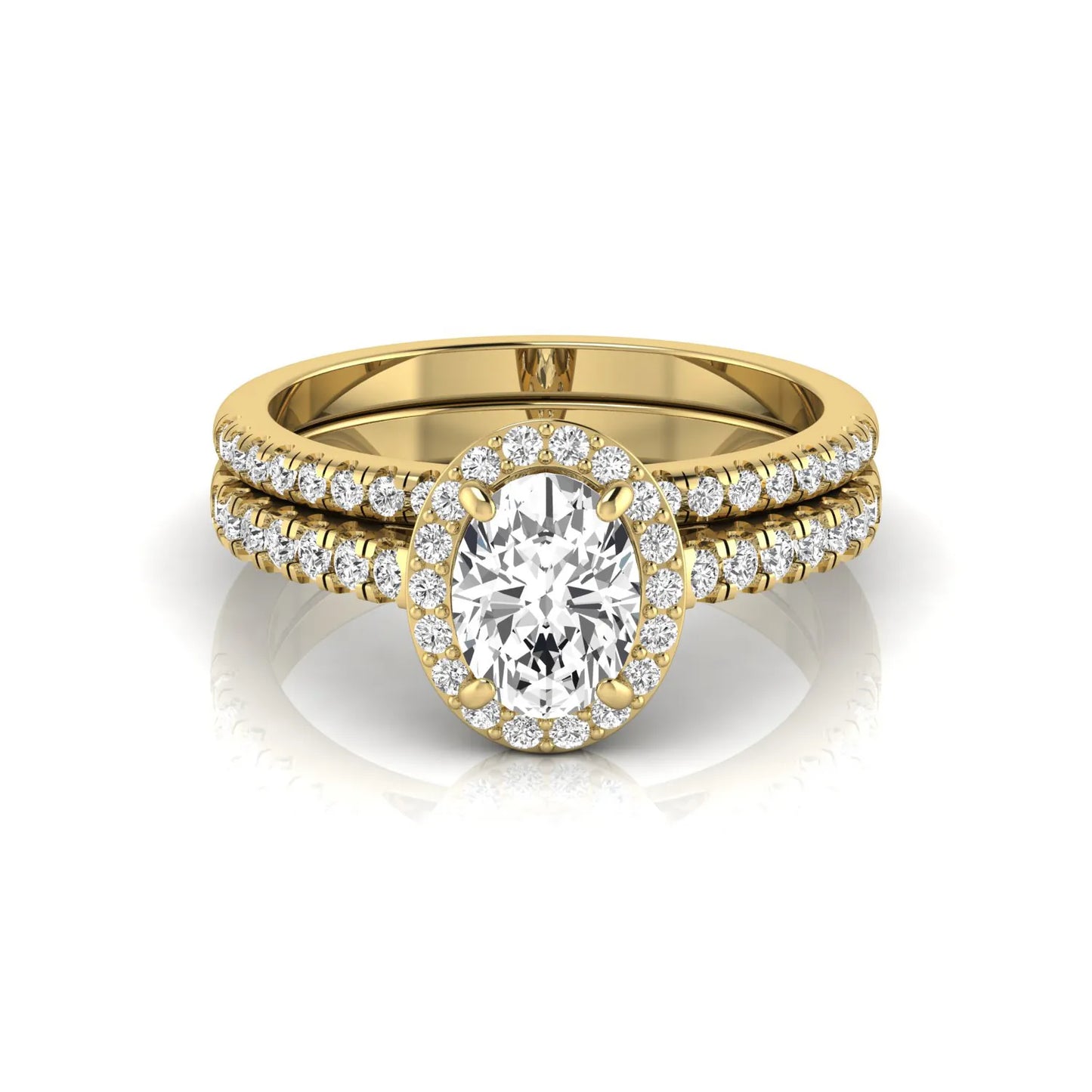 Oval halo lab grown diamond bridal ring set featuring an IGI certified oval cut center diamond with round pavé diamonds in a classic halo setting and matching wedding band in yellow gold