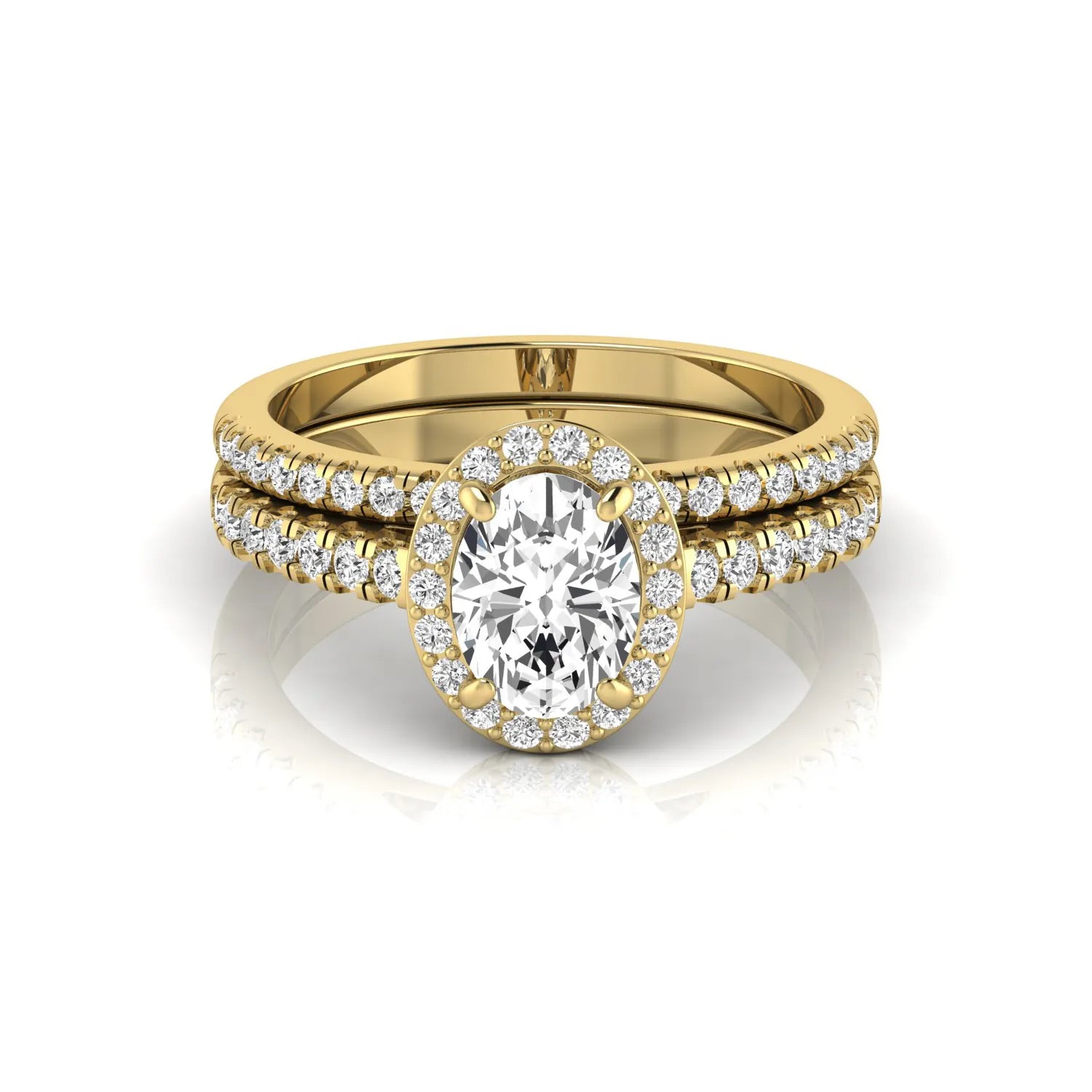 Oval halo lab grown diamond bridal ring set featuring an IGI certified oval cut center diamond with round pavé diamonds in a classic halo setting and matching wedding band in yellow gold