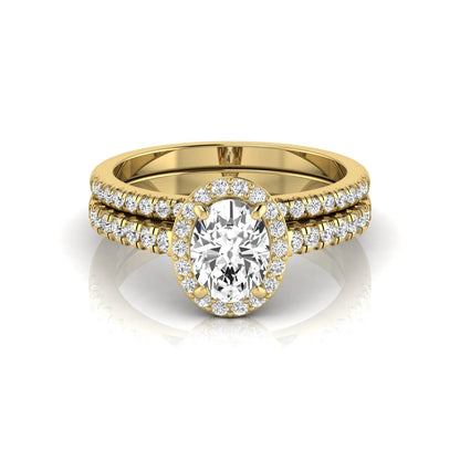 Oval halo lab grown diamond bridal ring set featuring an IGI certified oval cut center diamond with round pavé diamonds in a classic halo setting and matching wedding band in yellow gold