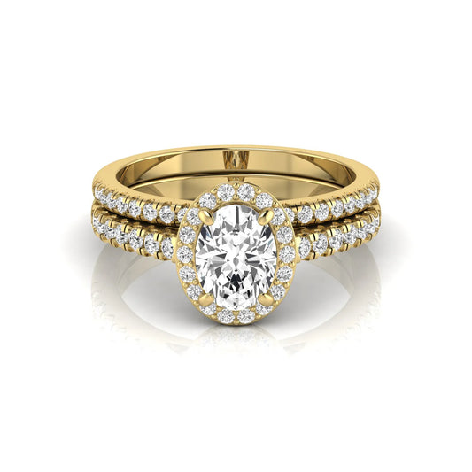 Oval halo lab grown diamond bridal ring set featuring an IGI certified oval cut center diamond with round pavé diamonds in a classic halo setting and matching wedding band in yellow gold