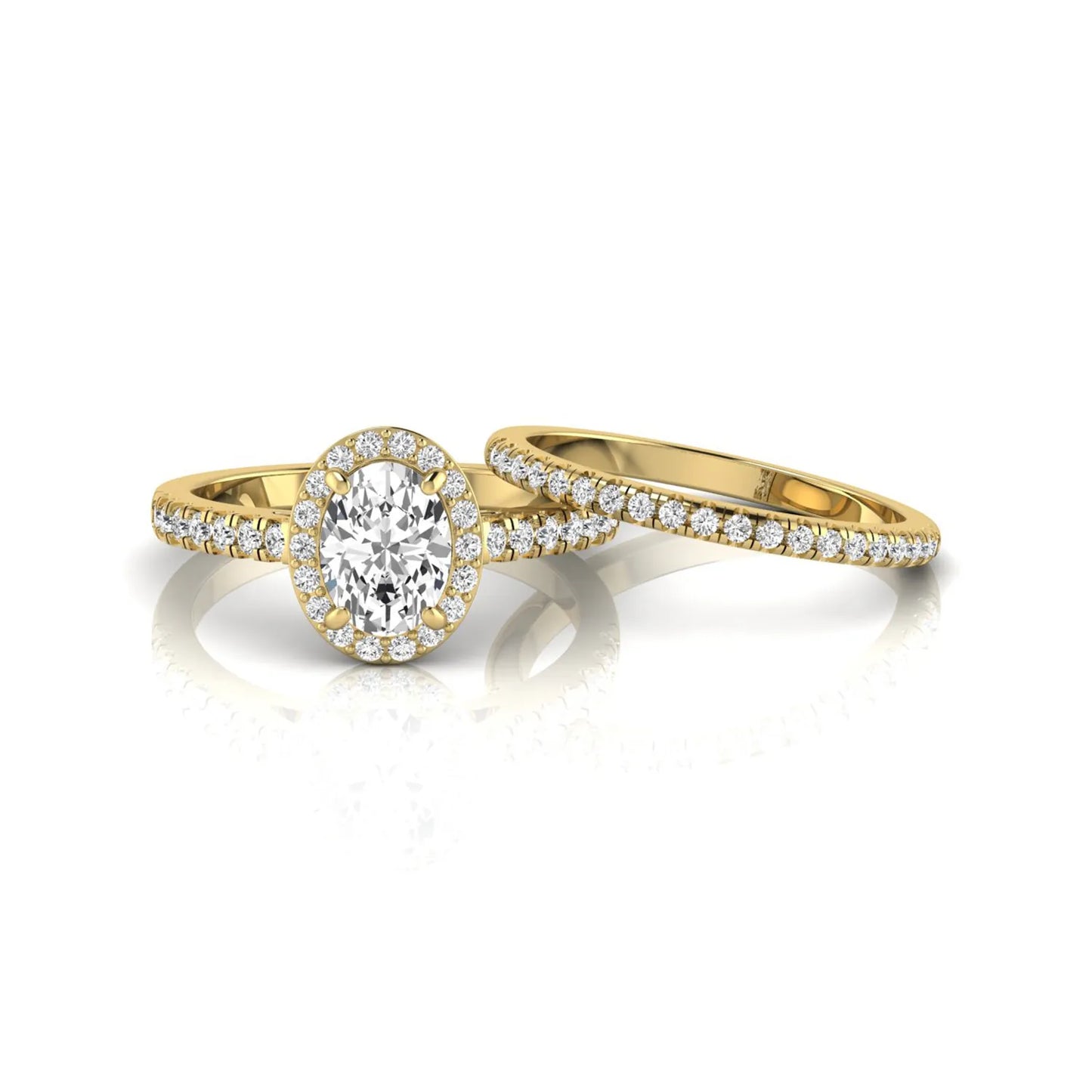 Oval halo lab grown diamond bridal ring set featuring an IGI certified oval cut center diamond with round pavé diamonds in a classic halo setting and matching wedding band in yellow gold